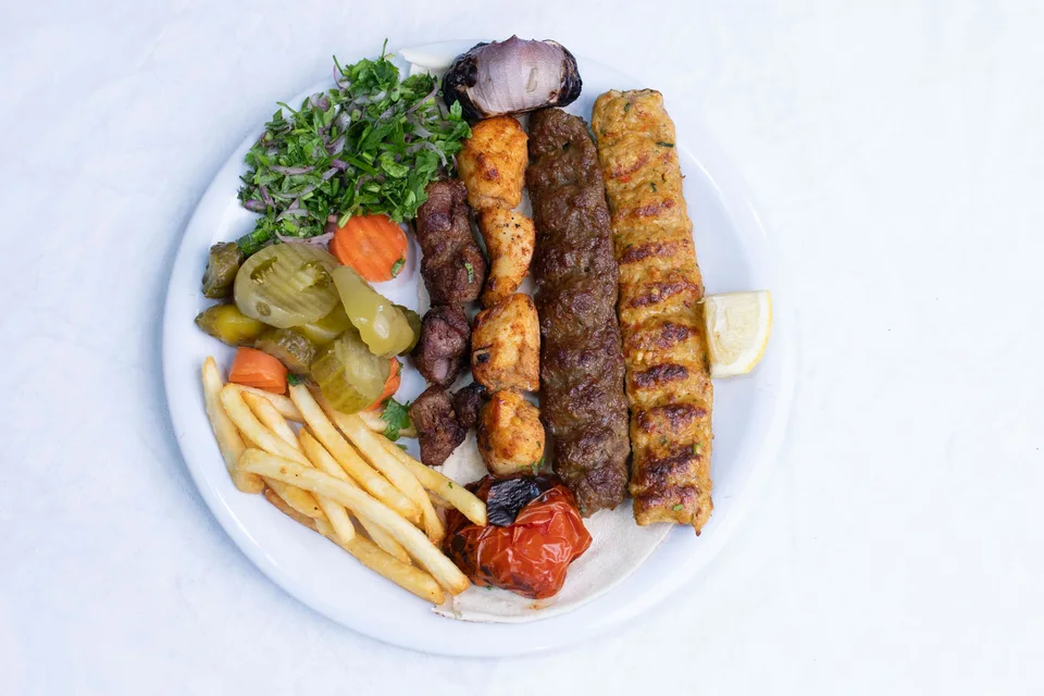Example photo: Grilled kebabs served with salad and fries